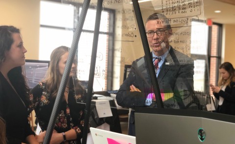 President James Herbert looks at a student project at the 2019 Student Innovation Challenge
