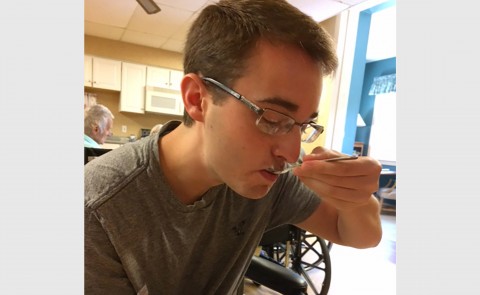 Joshua Allen experiences eating a meal while participating in nursing home immersion project