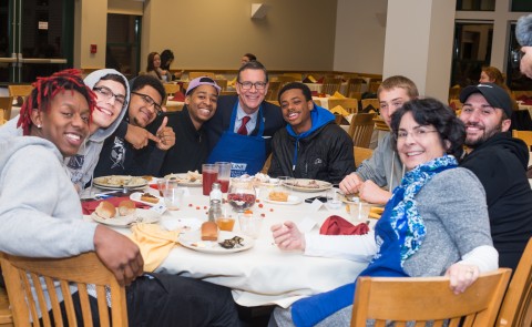 President Herbert and students at annual UNE Thanksgiving meal