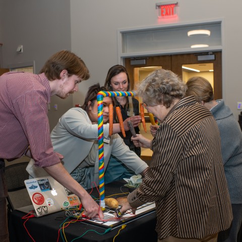Expo attendees play with a sensory piano created by M.S.O.T. students