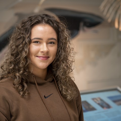 Portrait of Isabella Dube (Marine Affairs, ’24) in UNE's Marine Science Center