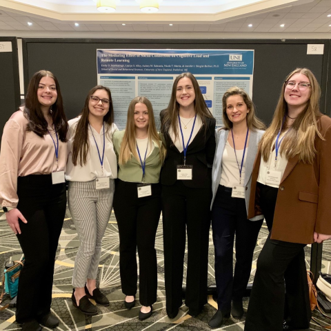 Five women students and a professor pose at the Eastern Psychological Association conference