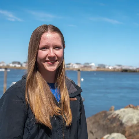 Portrait of a woman smiling in front of the ocean