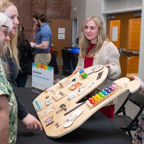 People observe a sensory board 