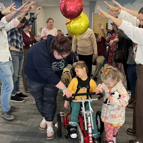 UNE’s students present adaptive bikes to children during Family Interprofessional Team sessions 