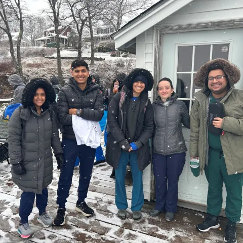 UNE students pose in the snow on Chebeague Island
