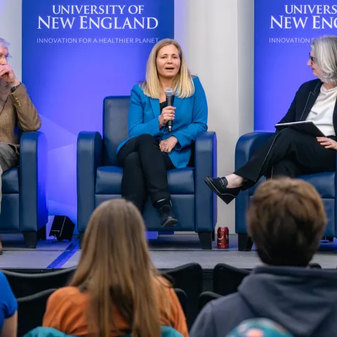 Three panelists discuss climate education onstage