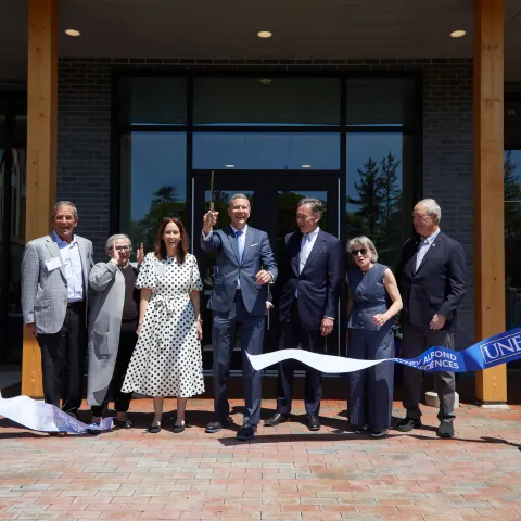 UNE administrators and trustees cut the ribbon for the Harold and Bibby Alfond Center for Health Sciences