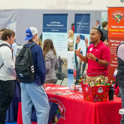 UNE students and employers talk at a career fair