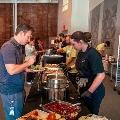 A Parkhurst employee serves a lunch guest