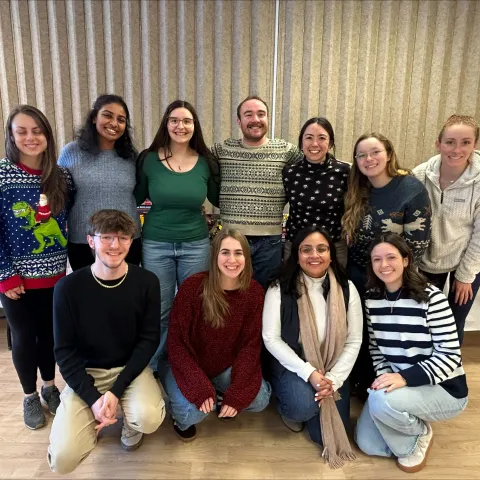 A group of students poses for a photo in UNE's Campus Center