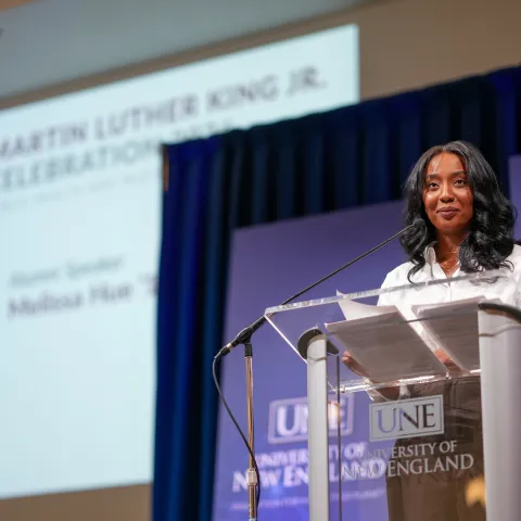 Melissa Hue standing at podium at MLK event