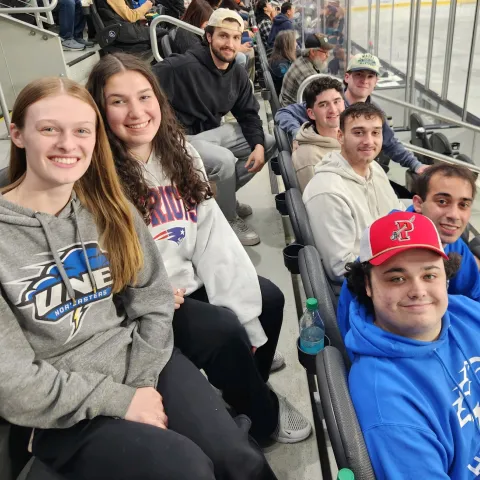 UNE business students pose for a photo at a San Jose Sharks game