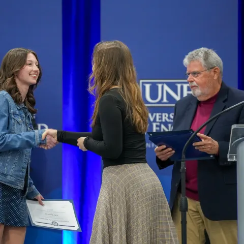 people shaking hands at this year's University Awards