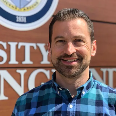 Headshot of Christopher RIzzo against blue background