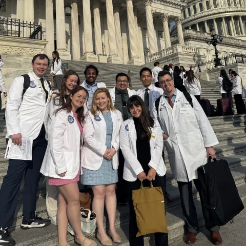 UNE medical students and faculty pose in front of the U.S. Capitol building