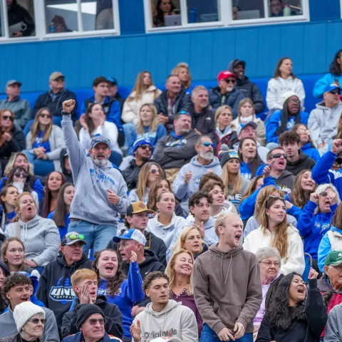 Fans cheer on UNE football in the stands