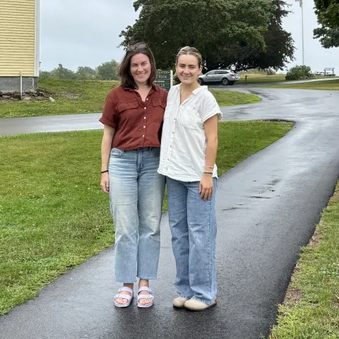 UNE student and mentor pose for outdoor photo