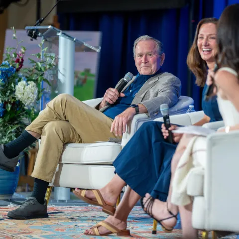 George W. Bush speaks in a panel onstage