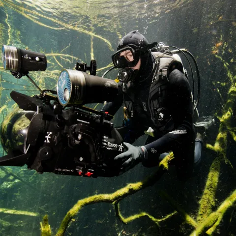 Underwater photo of cinematographer holding camera